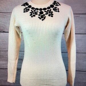 Elegant Cream Sweater with Black Embellishments